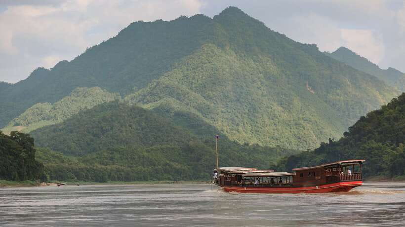 Luang Prabang: Pak Ou Caves & Kuang Si Falls Day Trip - Whiskey Village and the long ride to Kuang Si
